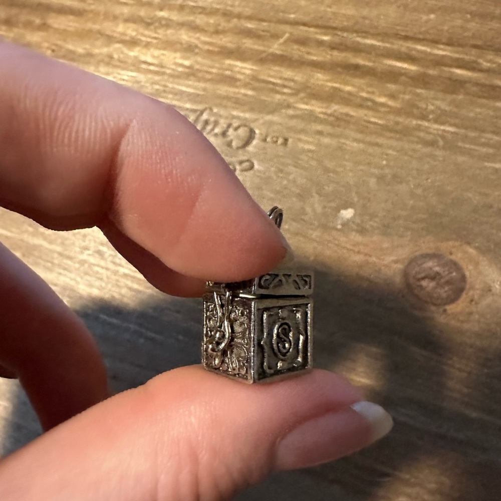 Sterling silver praying box charm.